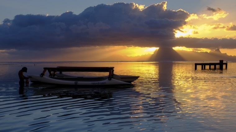 Outrigger canoe at sunset, French Polynesia